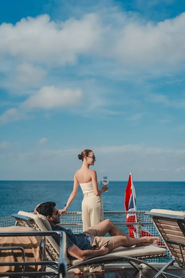 a man and woman on a boat aboard MOANA Yacht for Sale