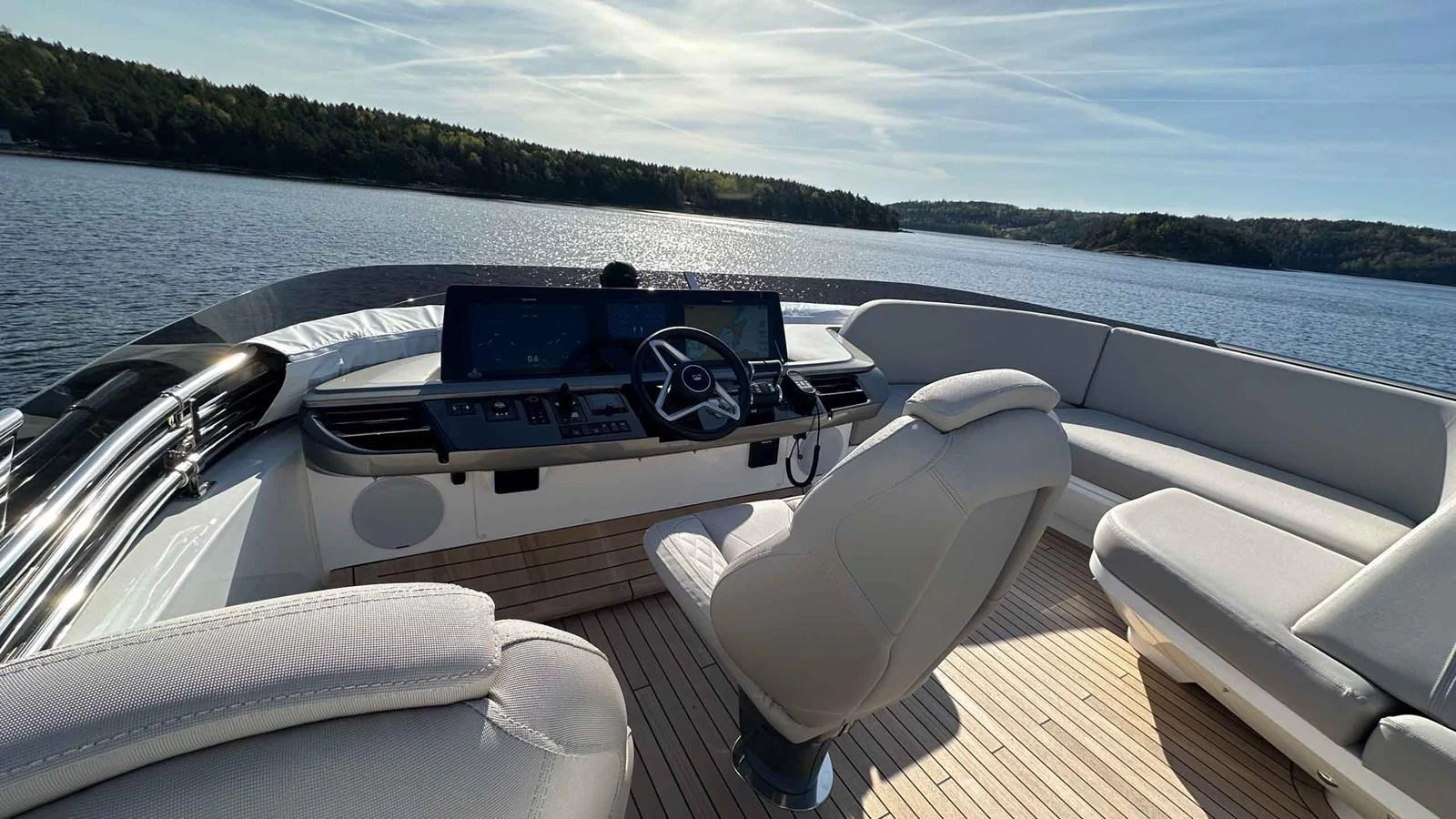 The helm station offers a commanding view with state-of-the-art navigation equipment and comfortable seating. aboard PRINCESS F65 Yacht for Sale
