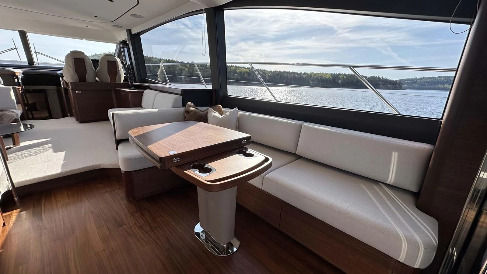 The salon features a spacious seating area with panoramic windows offering stunning views. aboard PRINCESS F65 Yacht for Sale