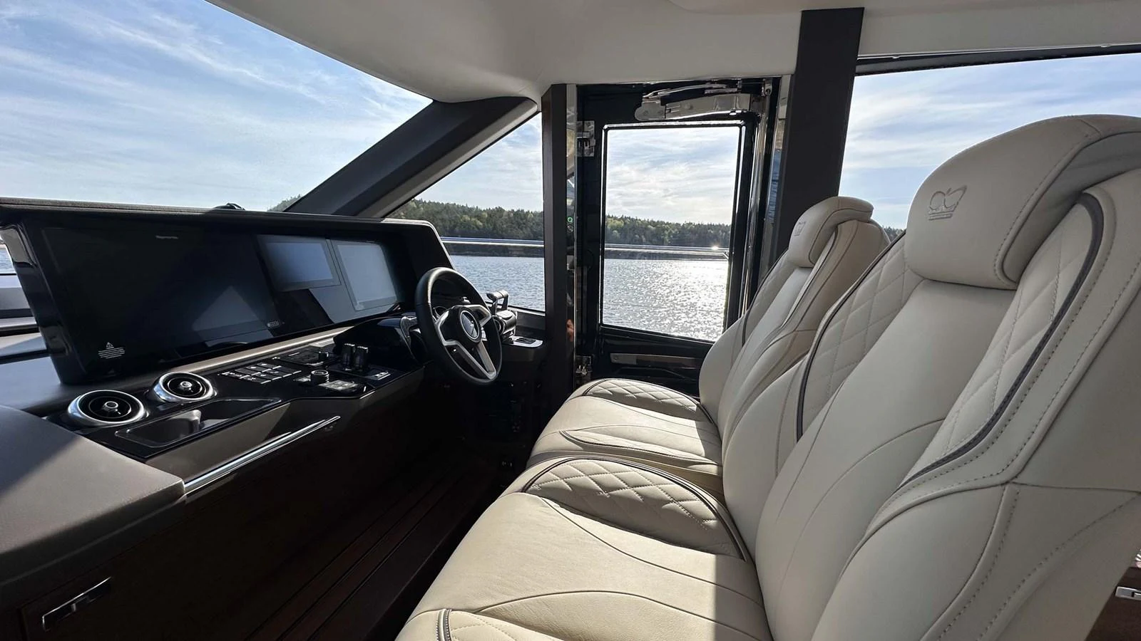 The helm area features luxurious seating and state-of-the-art navigation equipment with a panoramic view of the water. aboard PRINCESS F65 Yacht for Sale