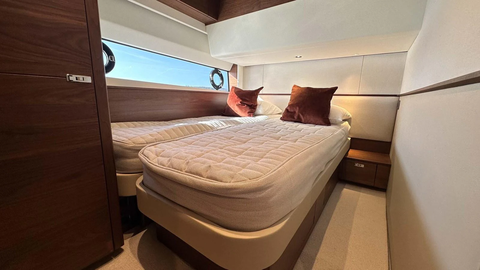 A cozy twin stateroom with modern furnishings and ample natural light. aboard PRINCESS F65 Yacht for Sale