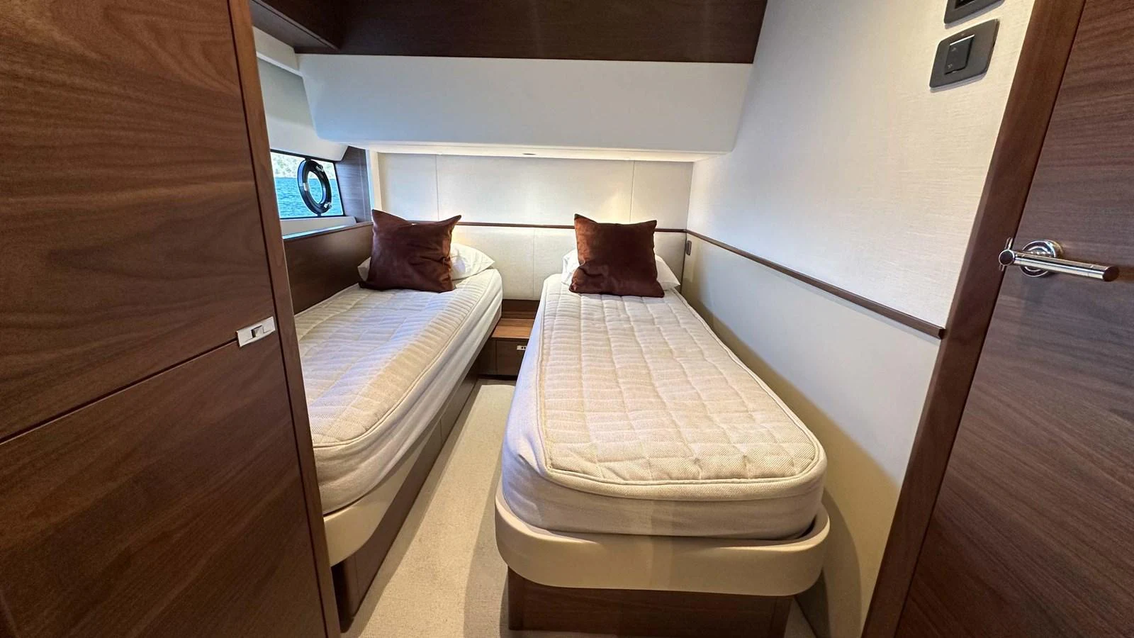 The twin stateroom features two single beds with plush pillows and a sleek, modern design. aboard PRINCESS F65 Yacht for Sale
