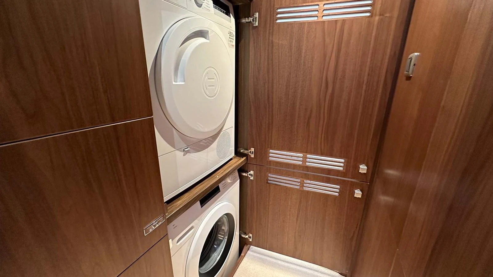 The yacht features a compact and efficient laundry room with modern appliances. aboard PRINCESS F65 Yacht for Sale