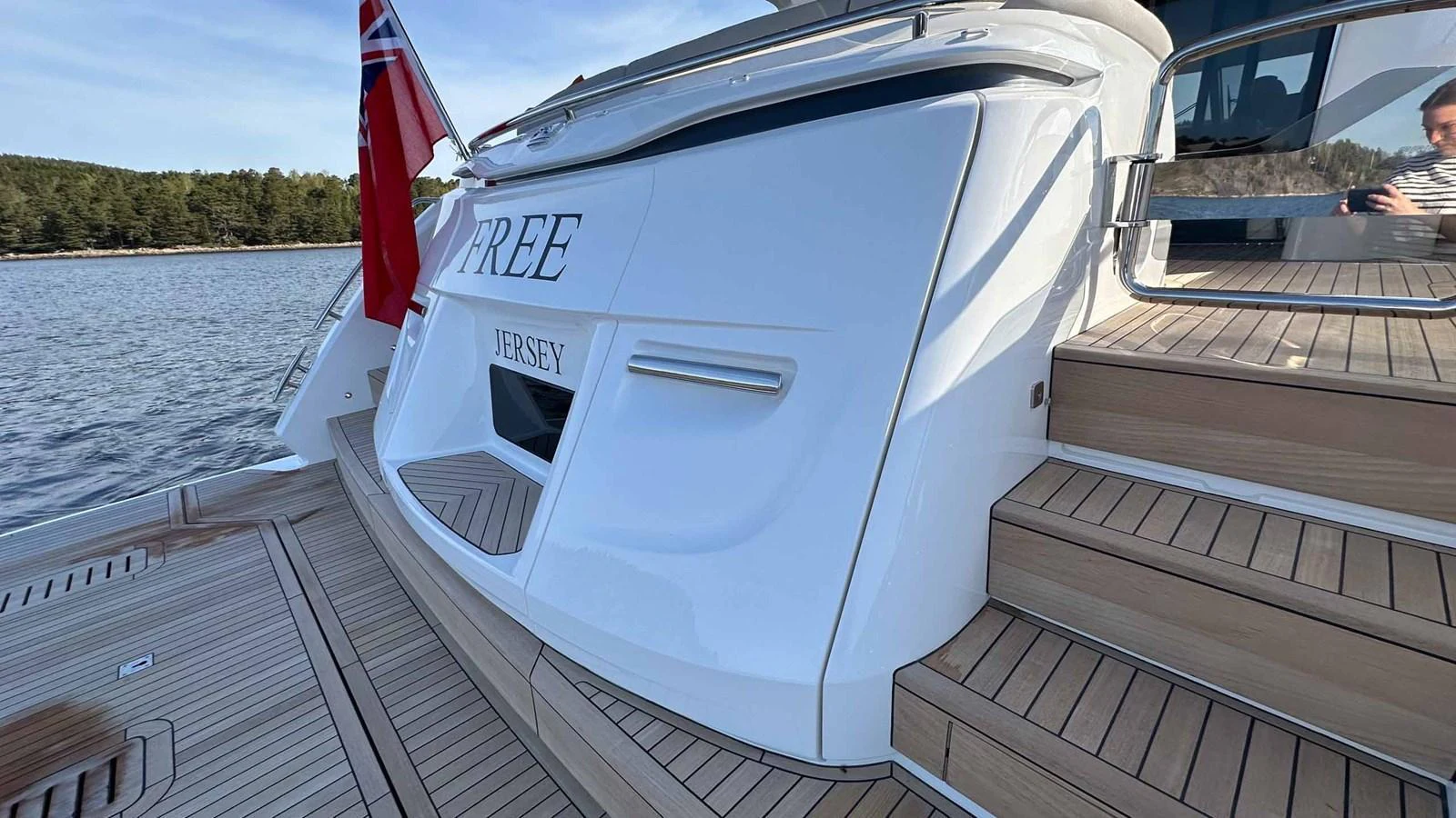 The yacht's aft deck features elegant teak steps and a sleek, modern design. aboard PRINCESS F65 Yacht for Sale