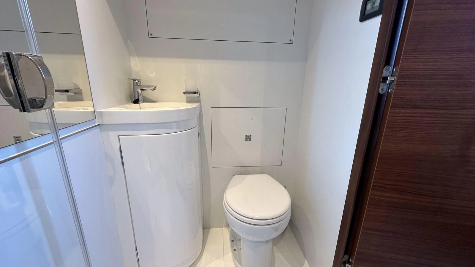 The yacht's head features a sleek, modern design with a compact sink and toilet. aboard PRINCESS F65 Yacht for Sale