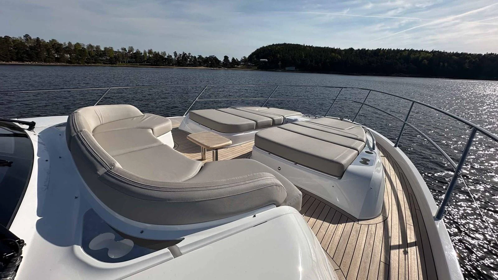 The foredeck features luxurious sunpads and comfortable seating with a scenic view of the water. aboard PRINCESS F65 Yacht for Sale
