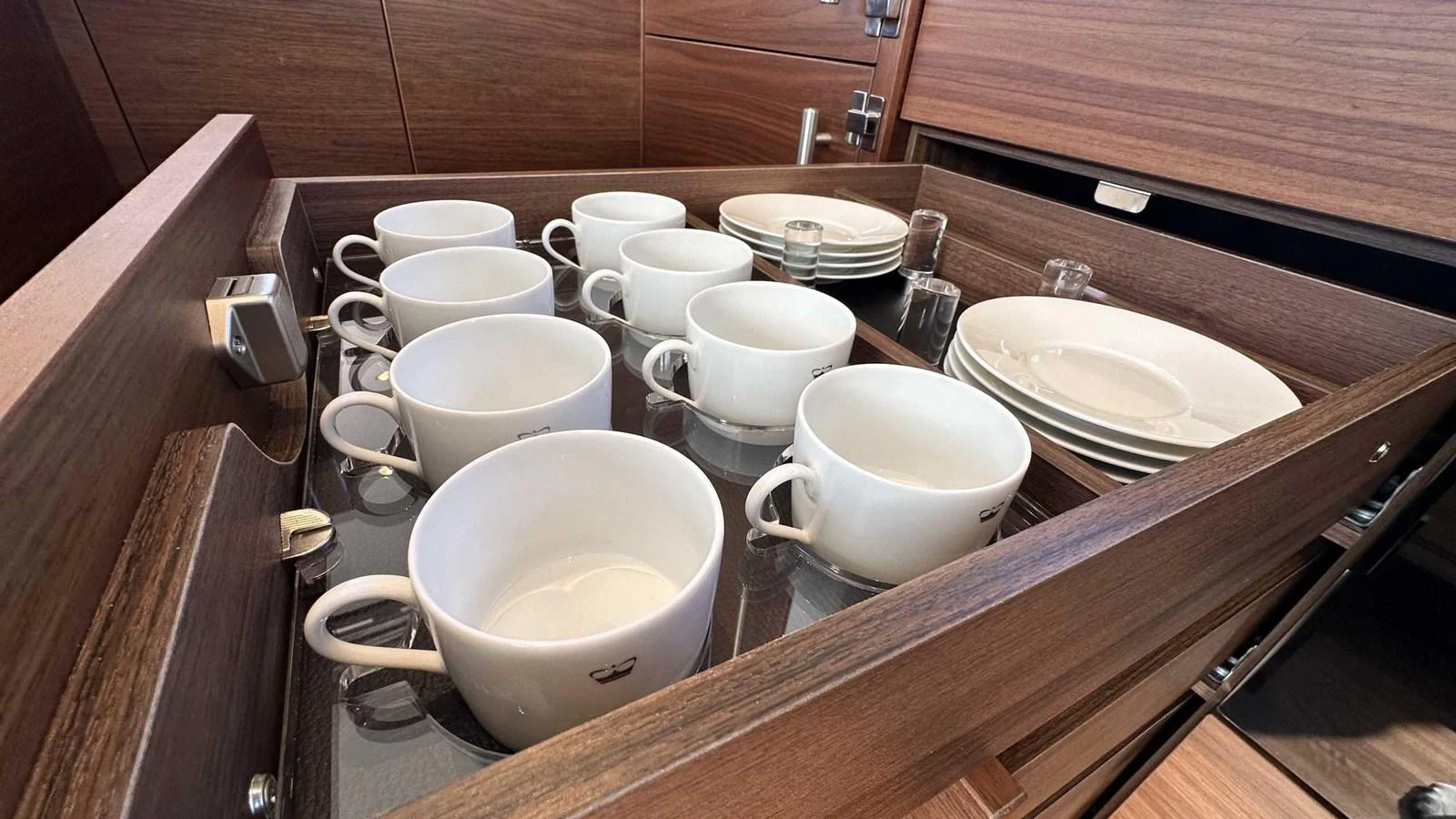 A neatly organized drawer with cups and plates showcases the yacht's attention to detail and functionality. aboard PRINCESS F65 Yacht for Sale