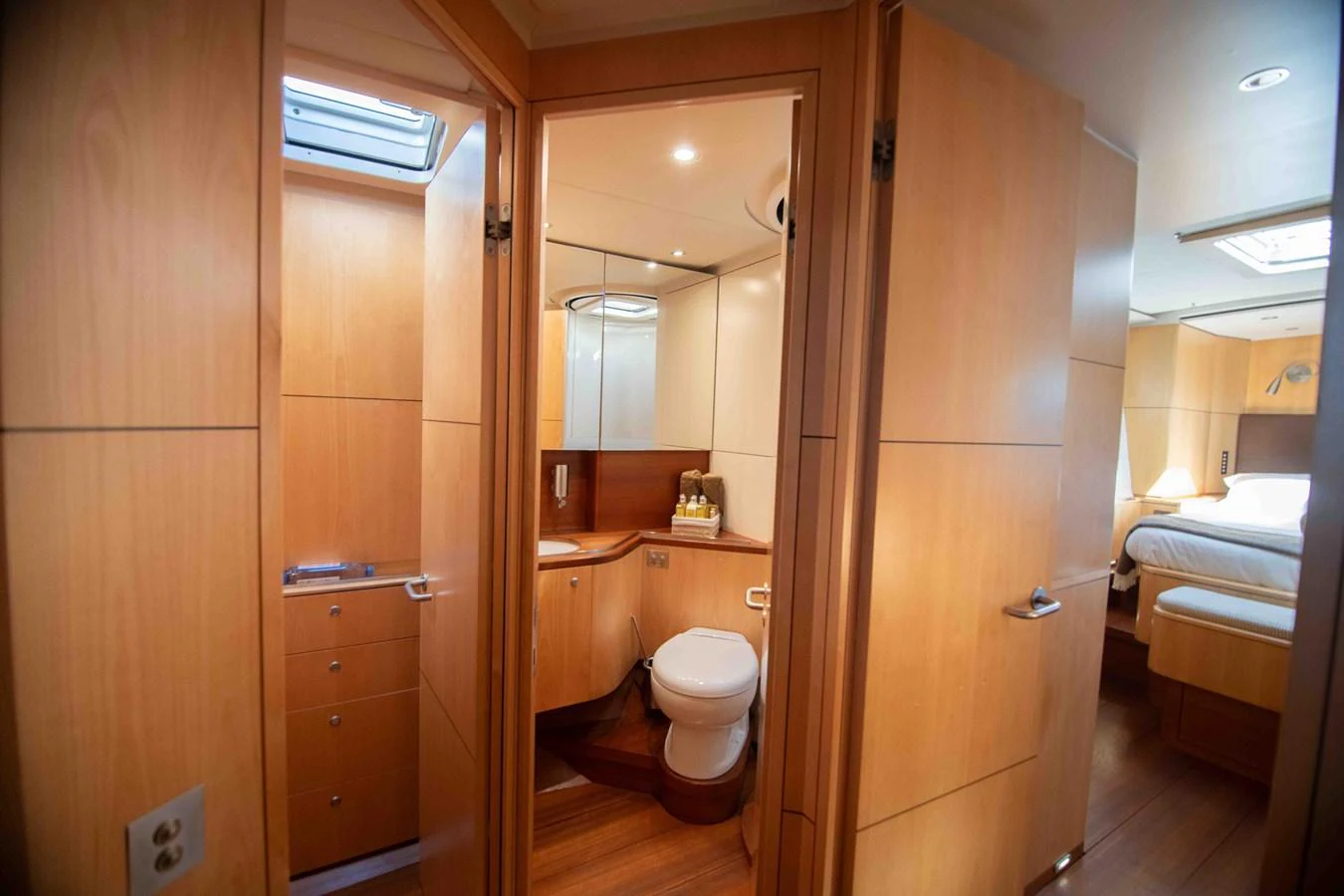 The yacht's head features elegant wood paneling and modern fixtures, creating a warm and inviting atmosphere. aboard BLACK PEARL II Yacht for Sale