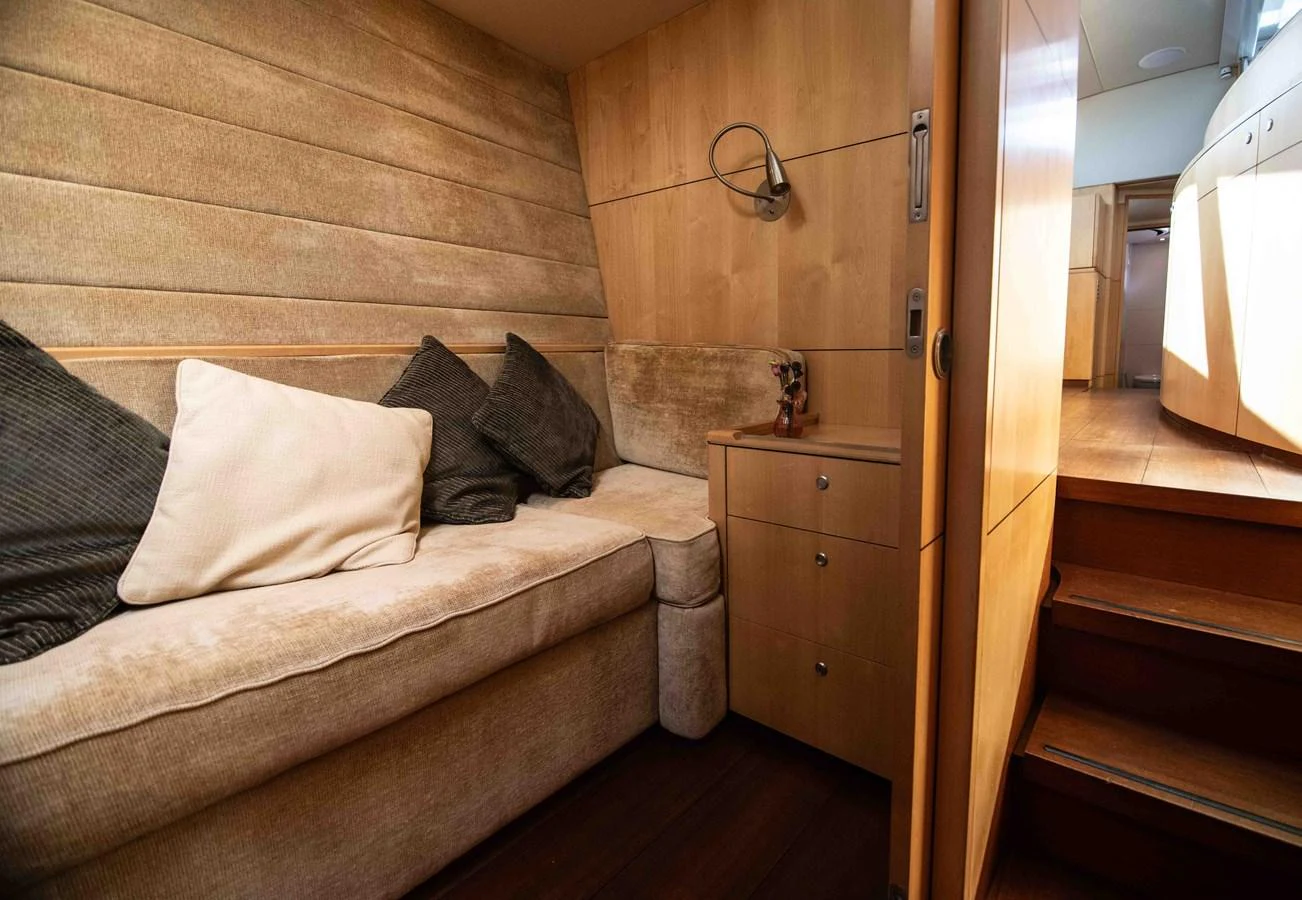 A cozy cabin with a comfortable seating area and wooden accents. aboard BLACK PEARL II Yacht for Sale