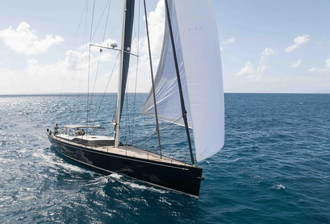 A sleek sailing yacht glides gracefully across the open sea under full sail. aboard BLACK PEARL II Yacht for Sale