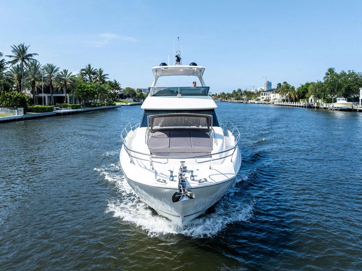 A sleek yacht cruises through a serene waterway, showcasing its elegant design and luxurious features. aboard JOVE Yacht for Sale