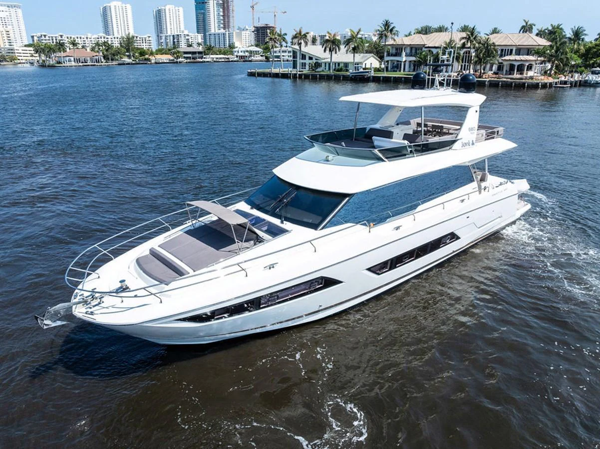 A sleek and modern yacht cruising in a serene waterfront setting. aboard JOVE Yacht for Sale