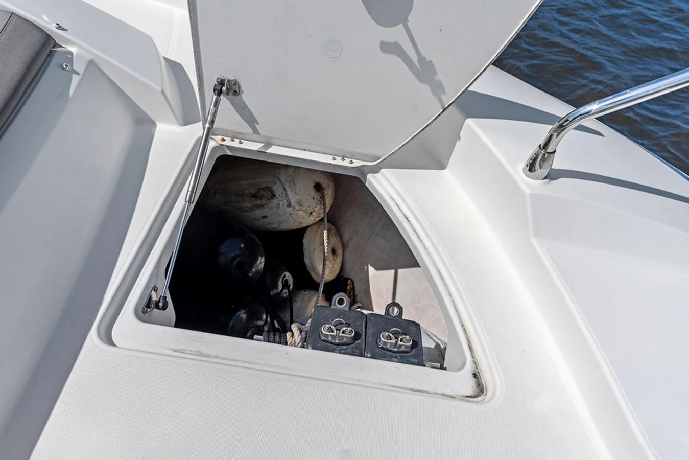 A close-up view of a storage compartment on the yacht, revealing various equipment and gear. aboard JOVE Yacht for Sale