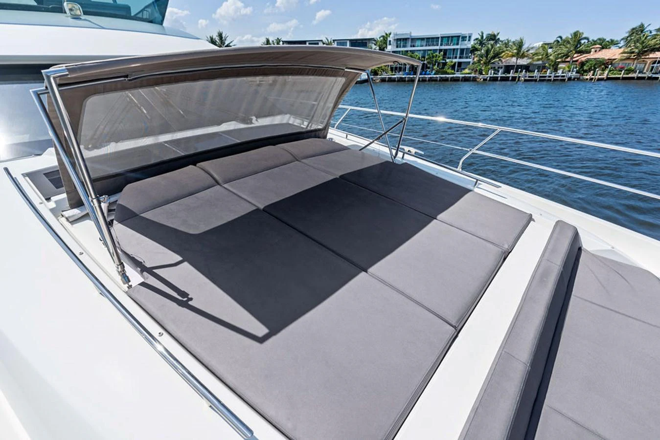 The sundeck features a spacious sunbathing area with comfortable cushions and a retractable sunshade. aboard JOVE Yacht for Sale
