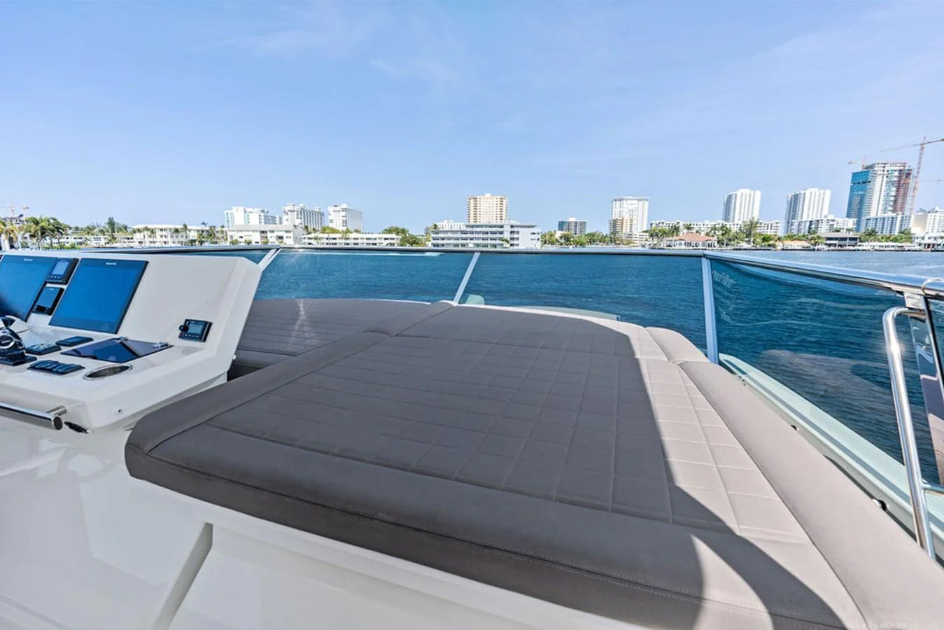 The sundeck offers a spacious lounging area with a scenic view of the water and cityscape. aboard JOVE Yacht for Sale