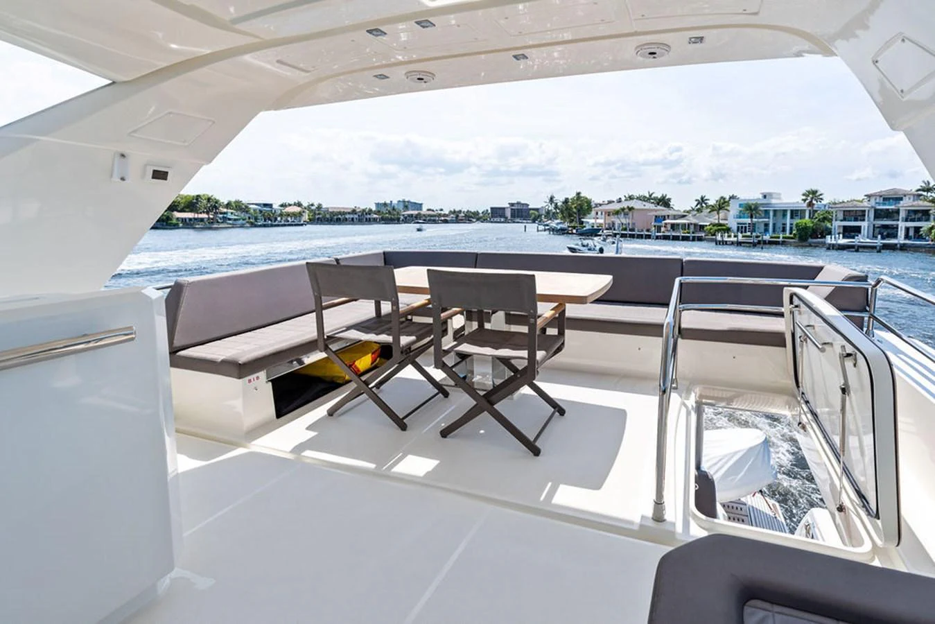 The aft deck offers a comfortable seating area with a dining table, perfect for enjoying meals with a view of the water. aboard JOVE Yacht for Sale