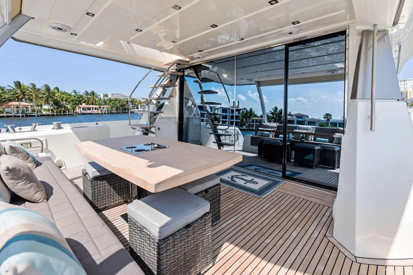 The aft deck features a spacious dining area with a large table and comfortable seating, perfect for alfresco meals. aboard JOVE Yacht for Sale