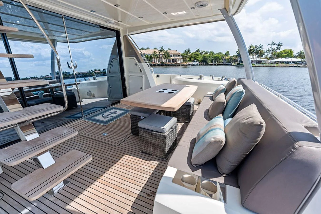 The aft deck features a comfortable seating area with a table, perfect for outdoor dining and relaxation. aboard JOVE Yacht for Sale
