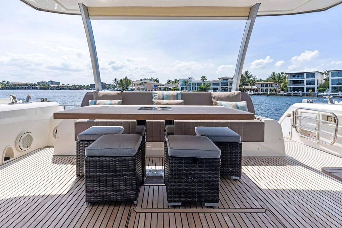 The aft deck features a stylish dining area with comfortable seating and a beautiful view of the water. aboard JOVE Yacht for Sale