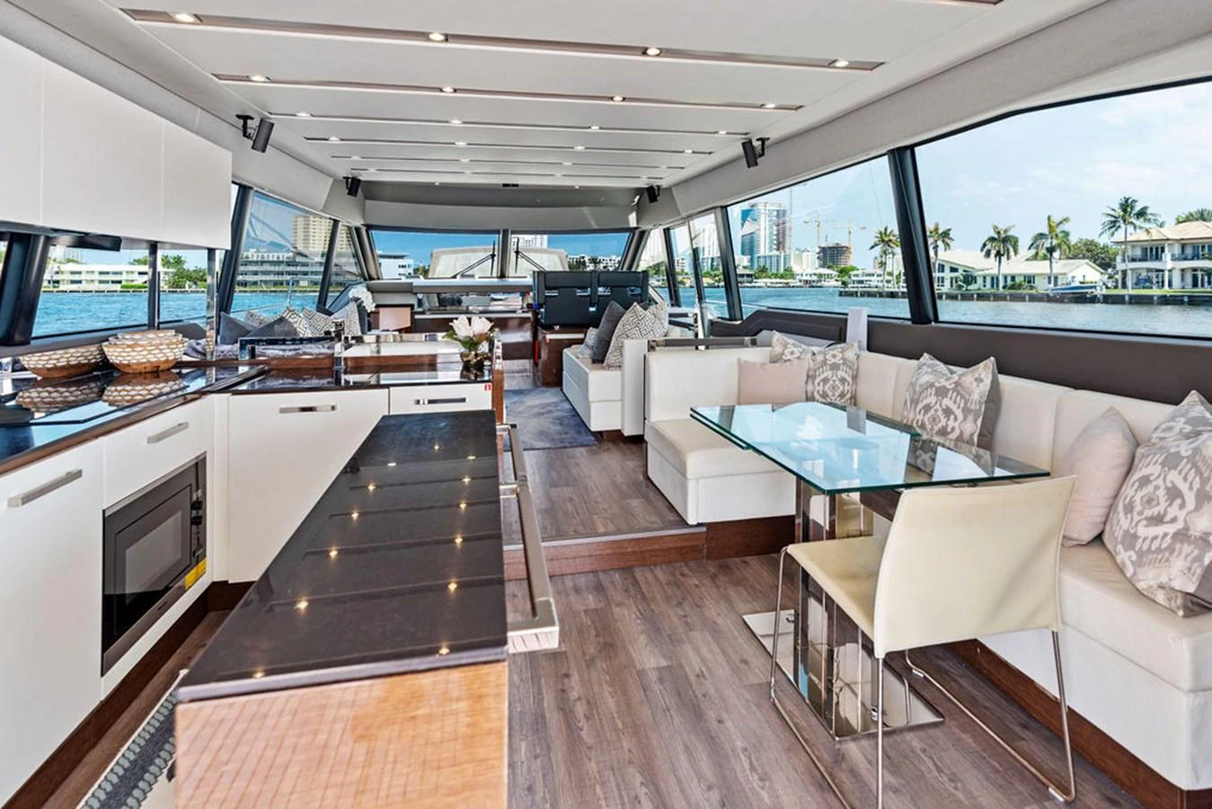 The salon features a spacious and modern design with ample seating and large windows offering panoramic views. aboard JOVE Yacht for Sale