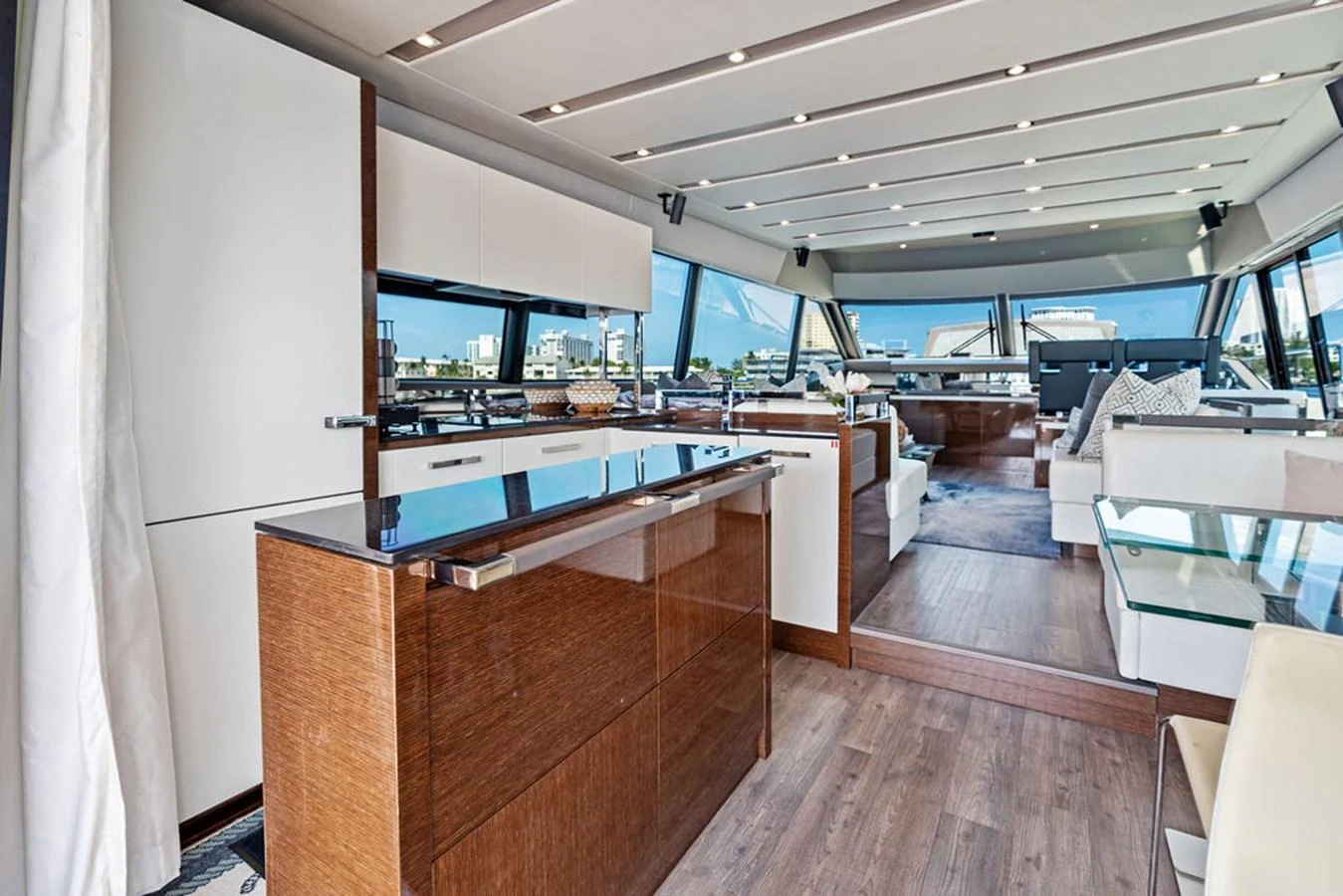 The spacious salon features modern furnishings and large windows for panoramic views. aboard JOVE Yacht for Sale