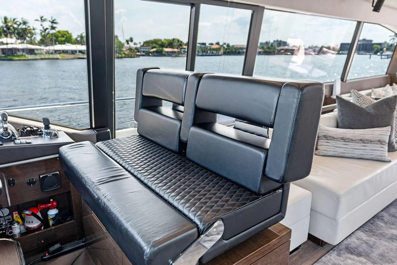 The helm area features a sleek, modern design with comfortable seating and expansive windows offering stunning water views. aboard JOVE Yacht for Sale