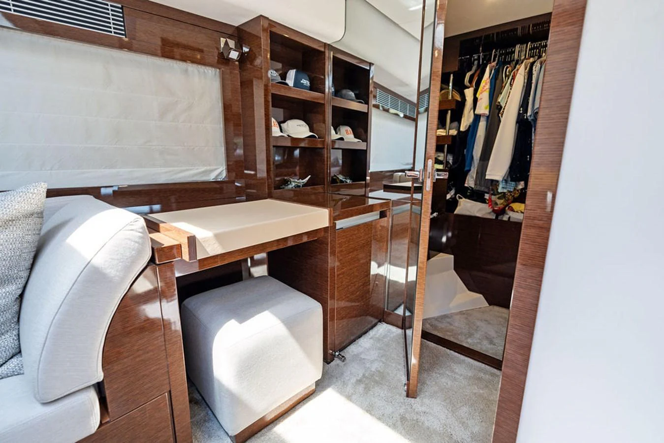 A well-appointed cabin featuring a desk, seating area, and ample storage space. aboard JOVE Yacht for Sale