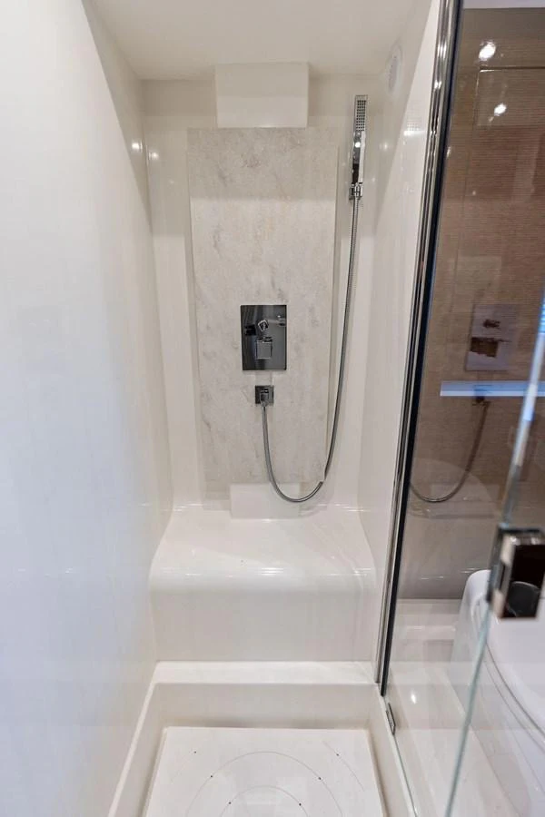 A sleek and modern yacht shower with a minimalist design. aboard JOVE Yacht for Sale