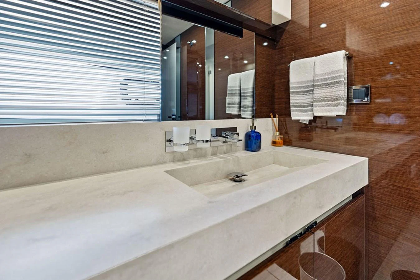 The bathroom features a sleek, modern design with a spacious countertop and elegant fixtures. aboard JOVE Yacht for Sale
