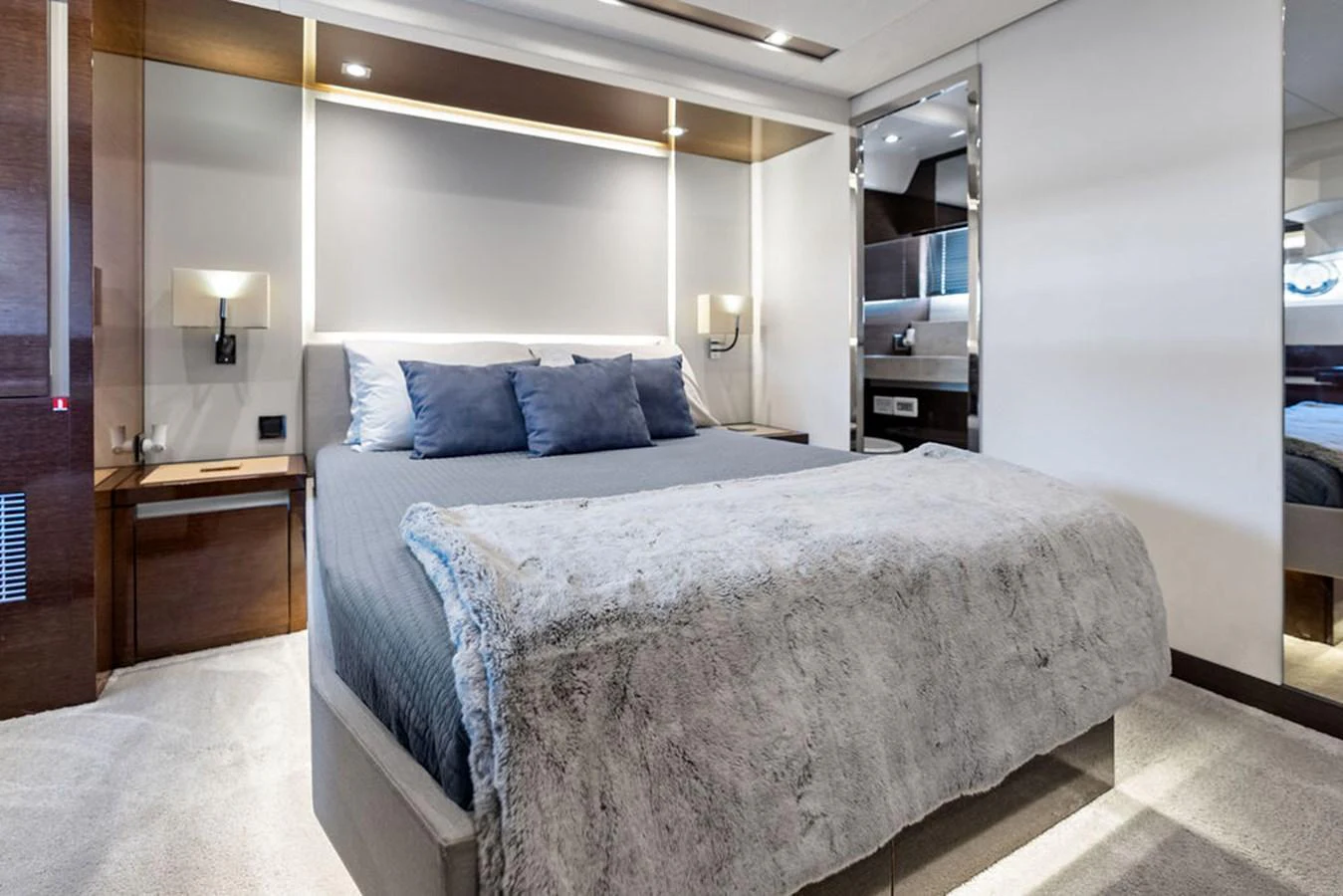 The stateroom features a plush bed with luxurious bedding and modern lighting. aboard JOVE Yacht for Sale