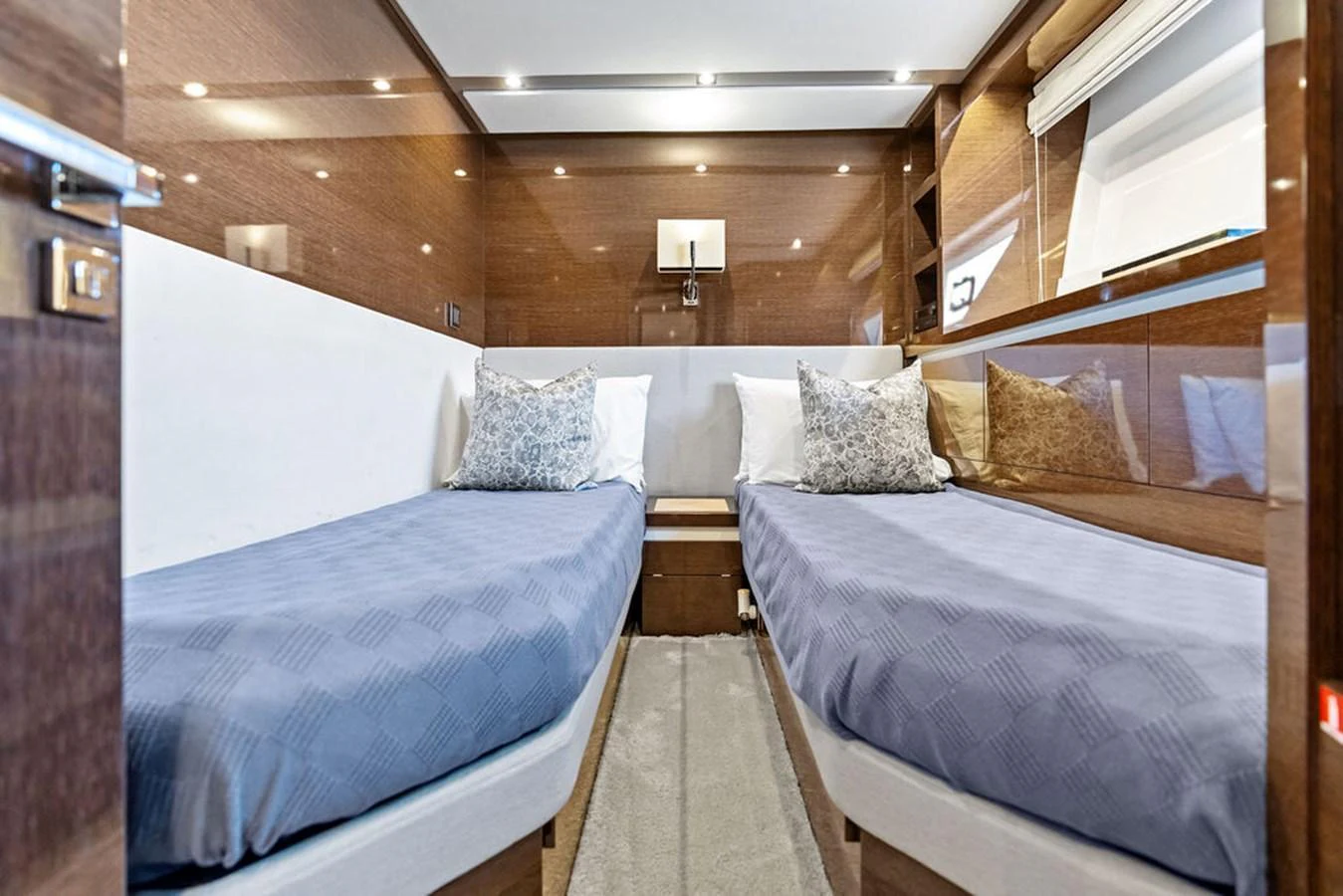 The twin stateroom features two comfortable beds with elegant bedding and a modern design. aboard JOVE Yacht for Sale