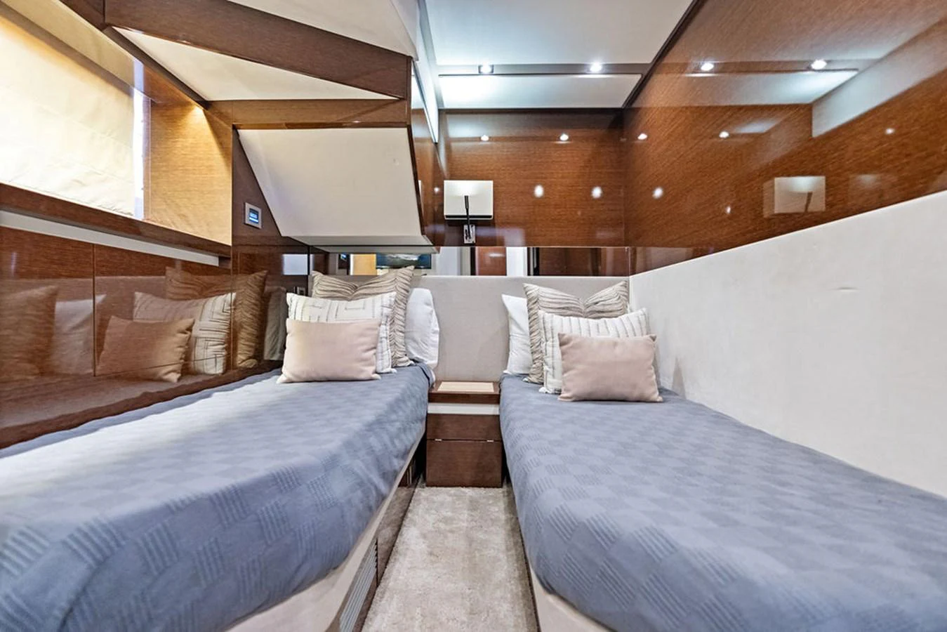 The twin stateroom offers a cozy and elegant sleeping area with two single beds and plush pillows. aboard JOVE Yacht for Sale