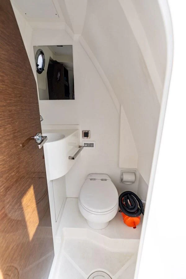 A compact and well-appointed yacht head with modern fixtures. aboard JOVE Yacht for Sale