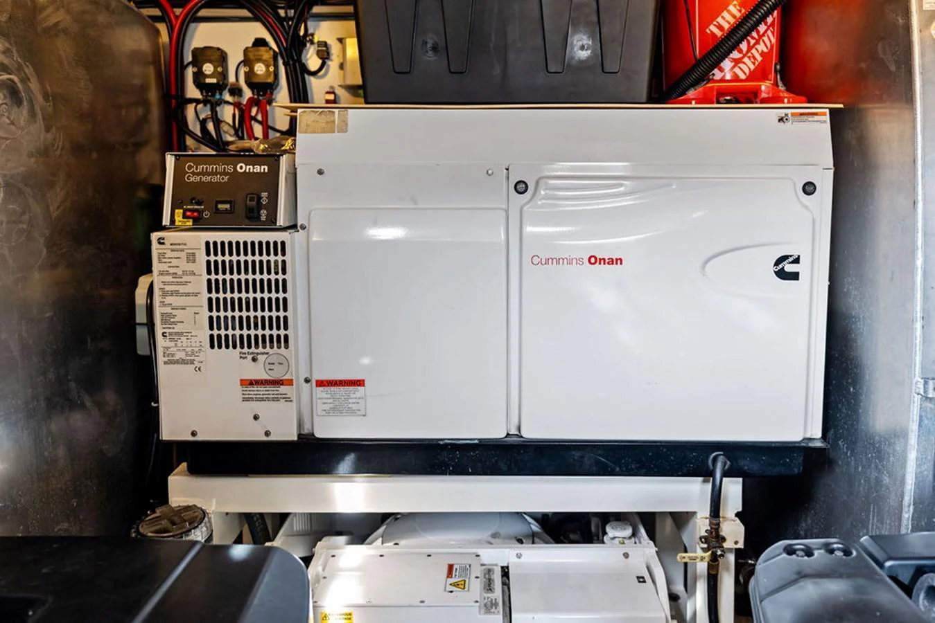 The image showcases the yacht's engine room with a Cummins Onan generator. aboard JOVE Yacht for Sale