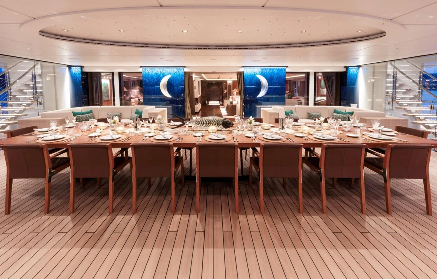 The yacht's dining area features an elegant, spacious setup with a long table and comfortable seating, perfect for hosting lavish meals. aboard LUNA Yacht for Sale