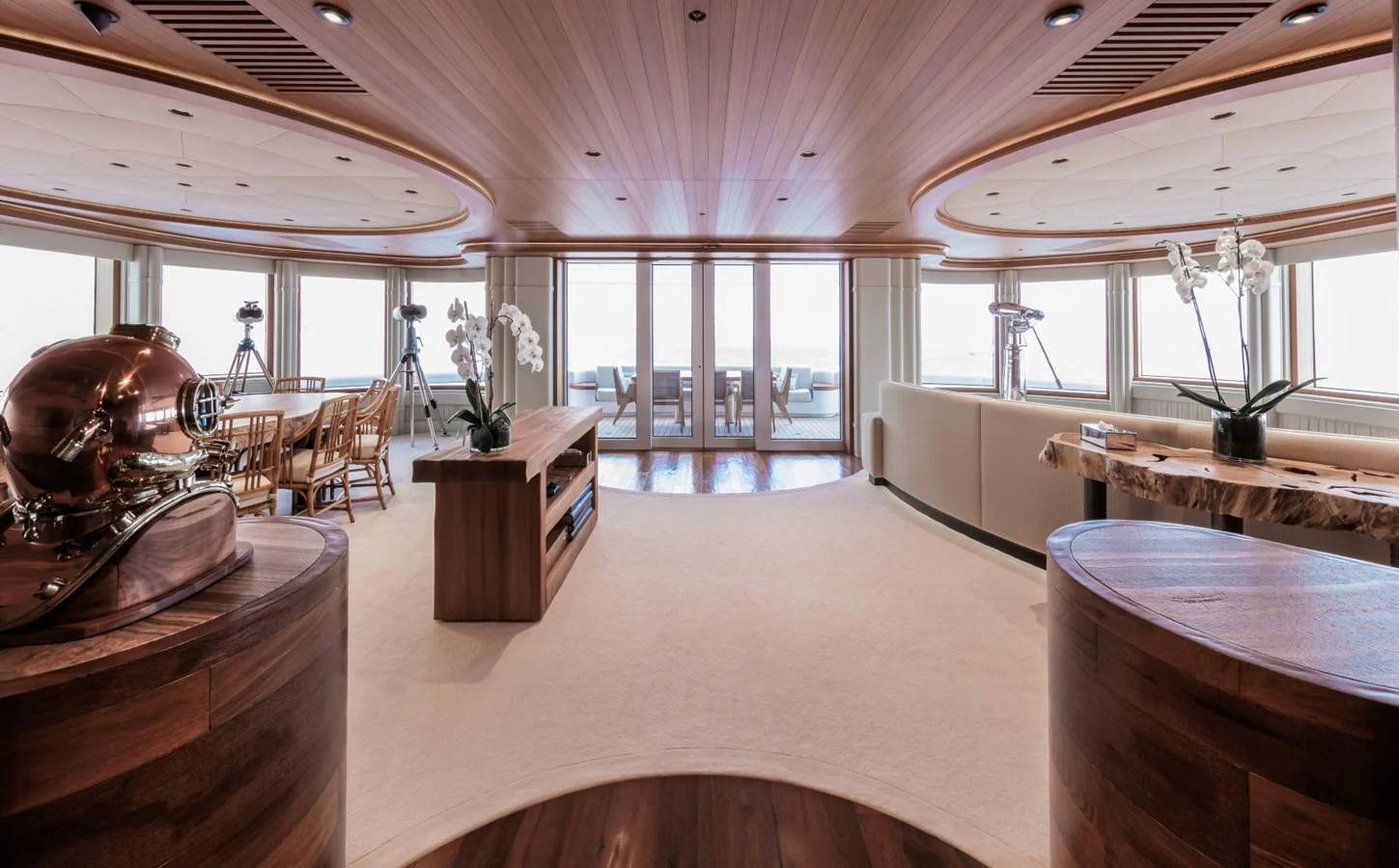 The yacht's interior features a spacious and elegantly designed lounge area with large windows offering stunning views. aboard LUNA Yacht for Sale