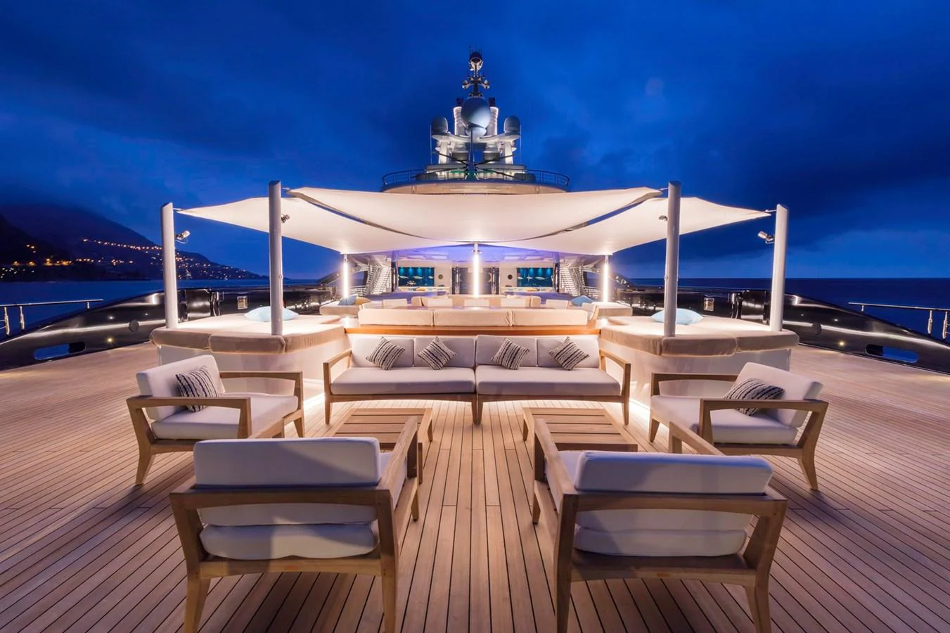 The sundeck of this yacht features elegant seating arrangements under a stylish canopy, perfect for evening relaxation. aboard LUNA Yacht for Sale