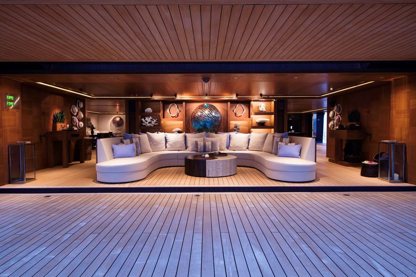 The yacht's salon features elegant wooden paneling and a spacious, curved seating area with plush cushions. aboard LUNA Yacht for Sale