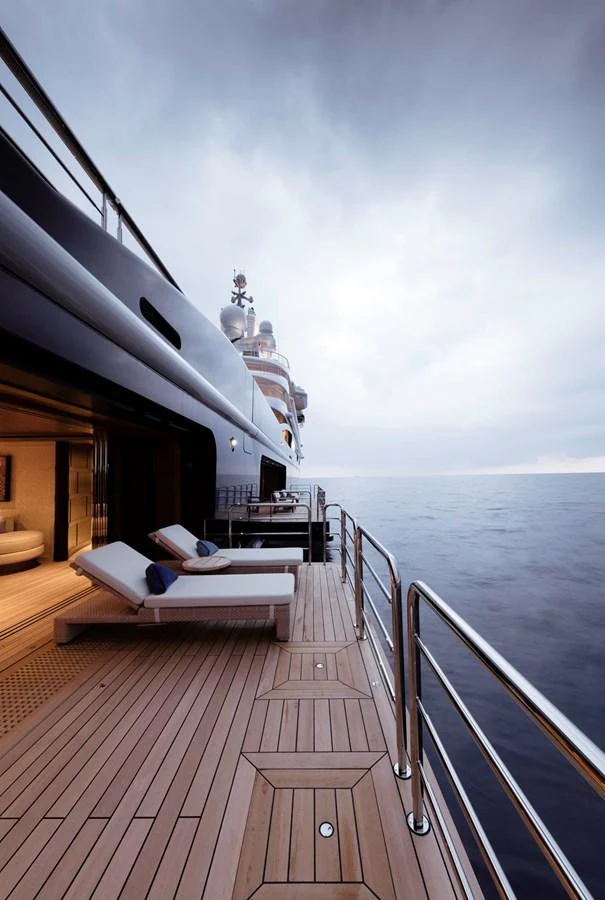 The yacht's deck offers a serene view of the open sea, complemented by luxurious lounge chairs for relaxation. aboard LUNA Yacht for Sale