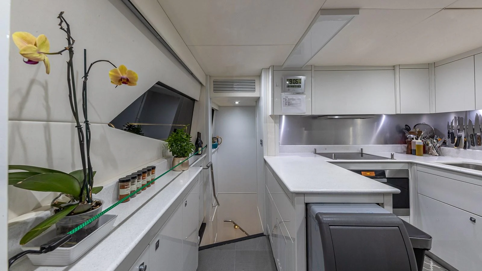 a kitchen with white cabinets aboard EMRYS Yacht for Sale