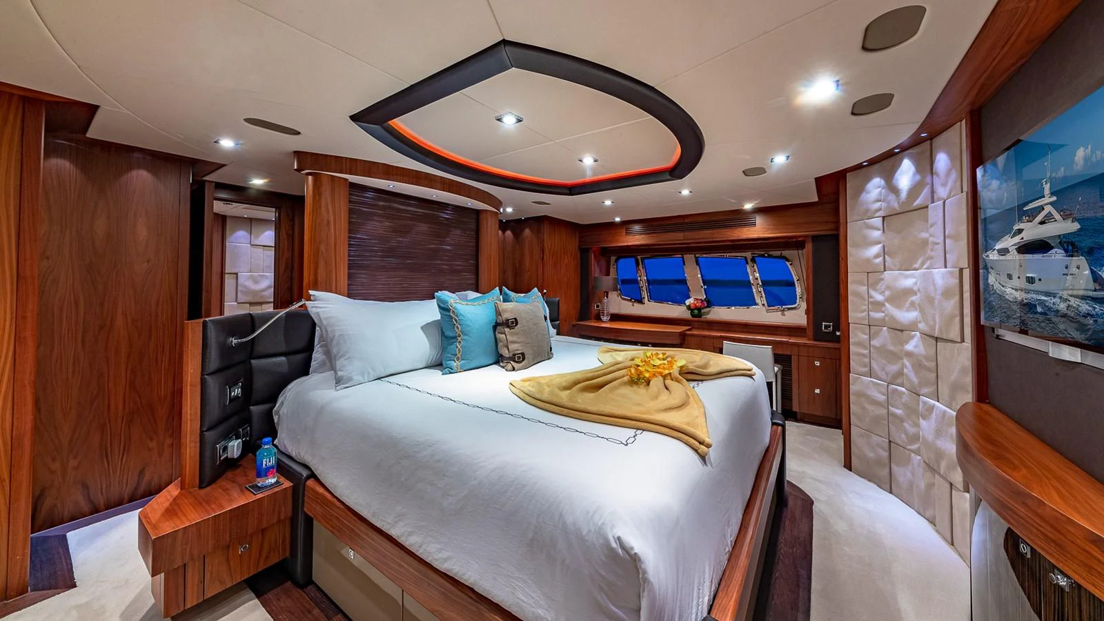 a bedroom with a bed and a table aboard EMRYS Yacht for Sale