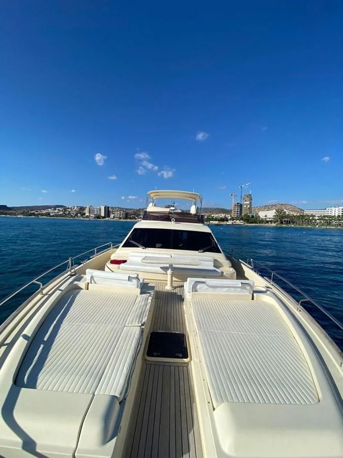 The yacht's bow area features spacious sun pads under a clear blue sky. aboard CARAMEL Yacht for Sale