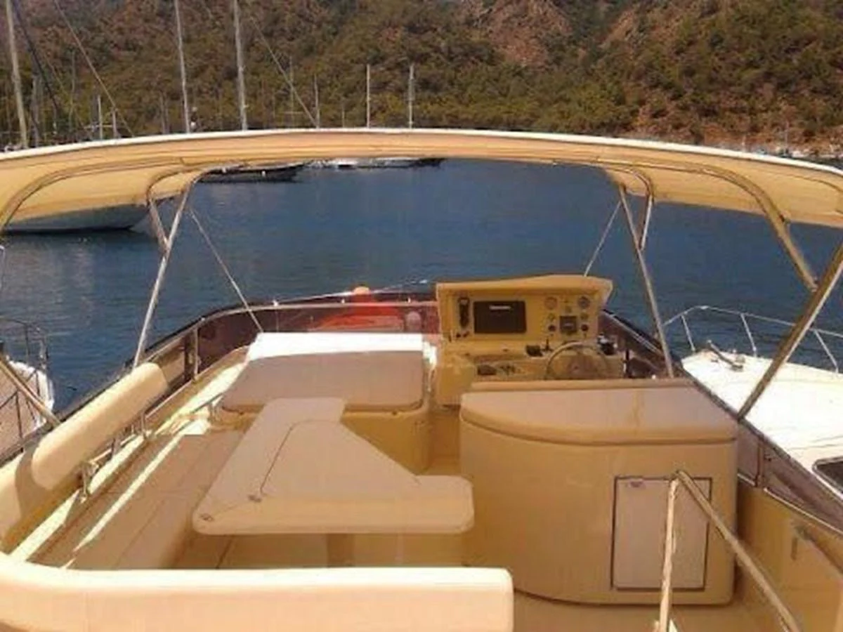 The flybridge offers a spacious and comfortable area with a helm station and ample seating, perfect for enjoying scenic views. aboard CARAMEL Yacht for Sale