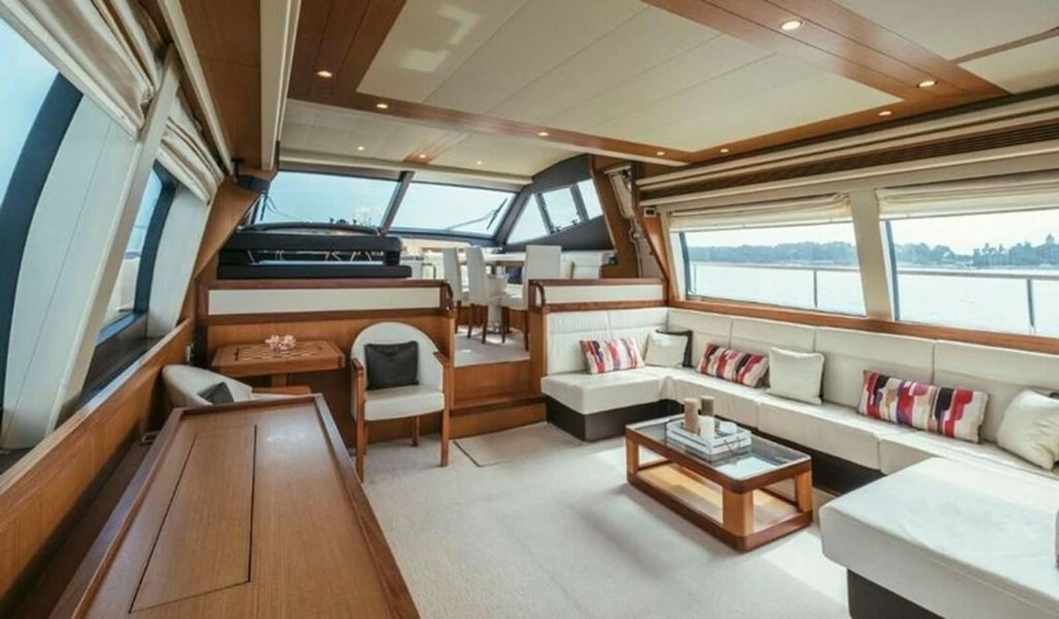 The yacht's salon features a spacious and elegant seating area with large windows offering panoramic views. aboard CARAMEL Yacht for Sale