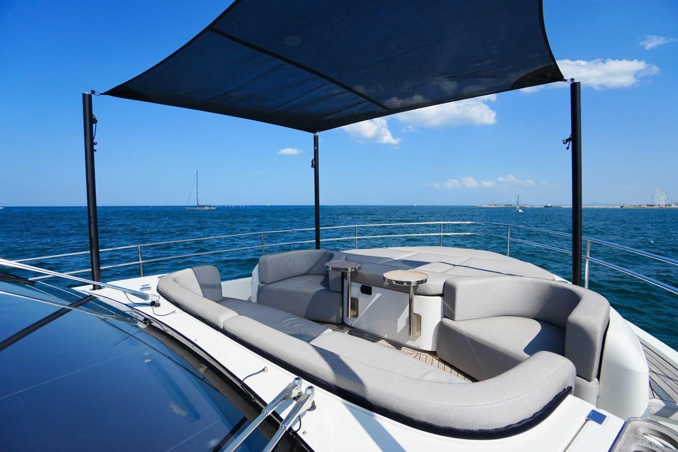 The sundeck offers a luxurious lounging area with a shade canopy, perfect for relaxation while enjoying the sea views. aboard AMY Yacht for Sale