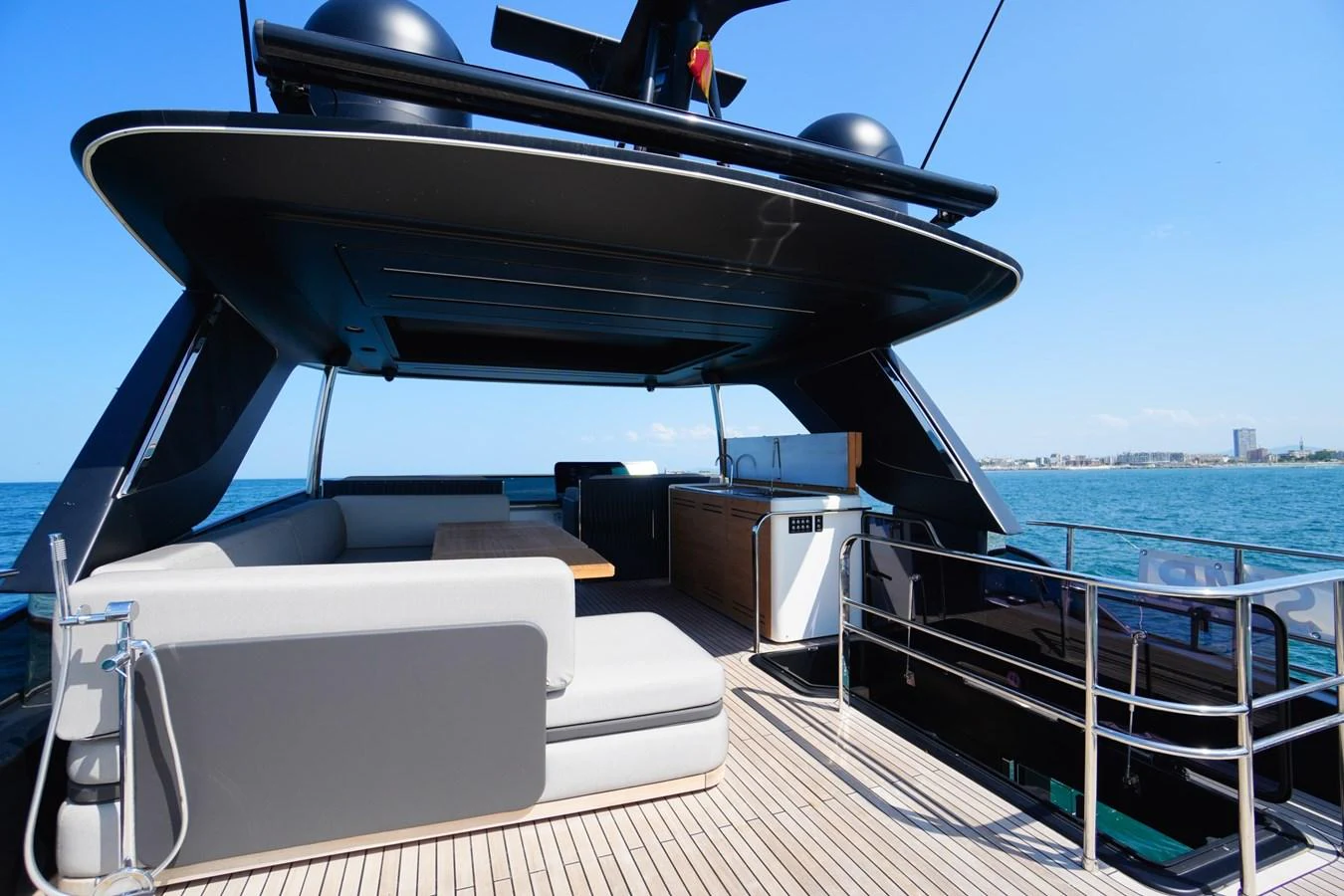 The aft deck features a spacious seating area with a sleek, modern design and stunning ocean views. aboard AMY Yacht for Sale