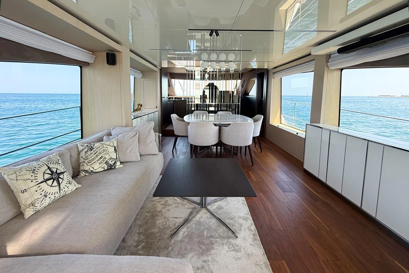The yacht's salon features a spacious seating area with large windows offering stunning ocean views. aboard AMY Yacht for Sale