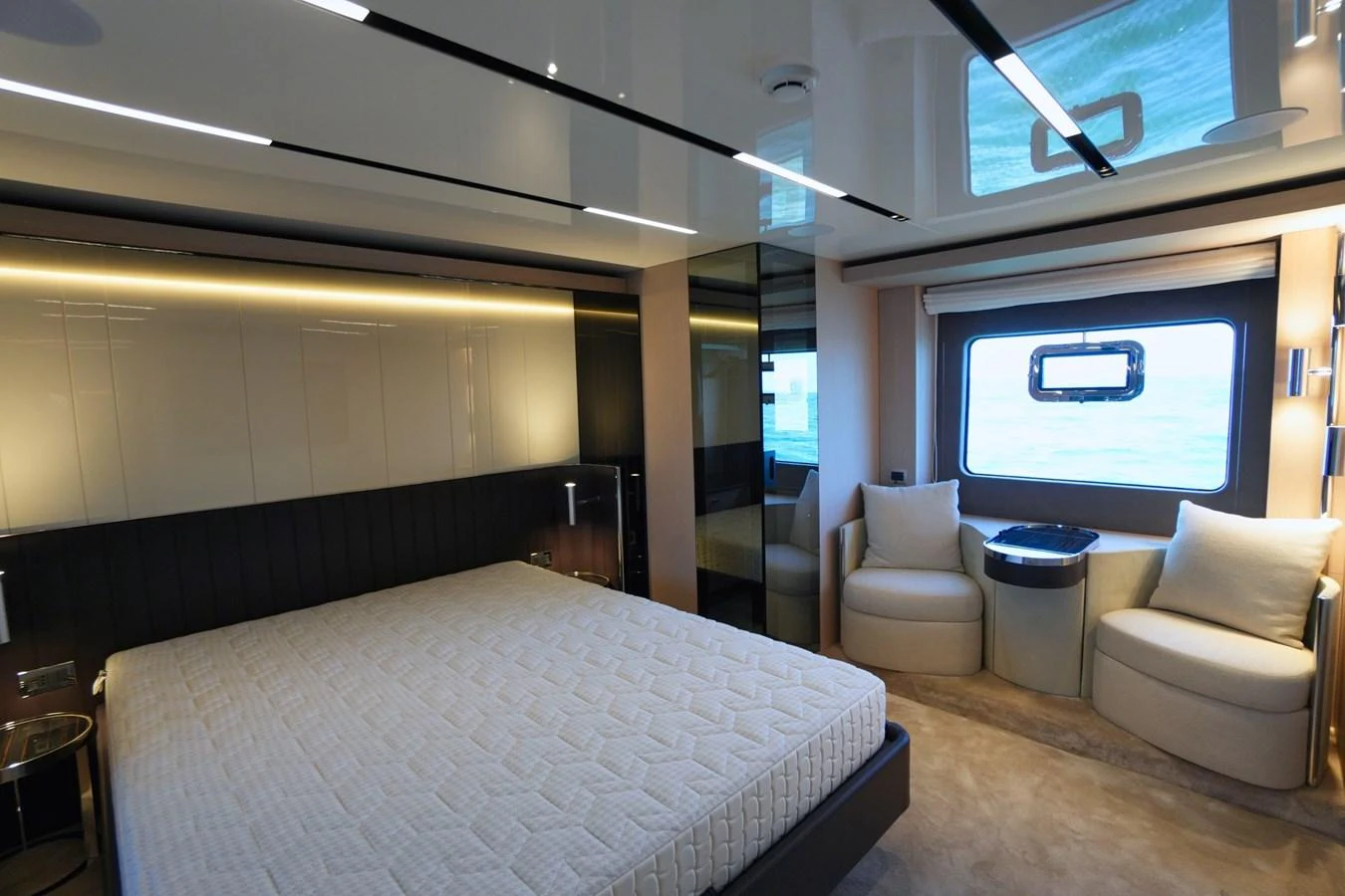 The master stateroom features a spacious bed, comfortable seating, and large windows for natural light. aboard AMY Yacht for Sale