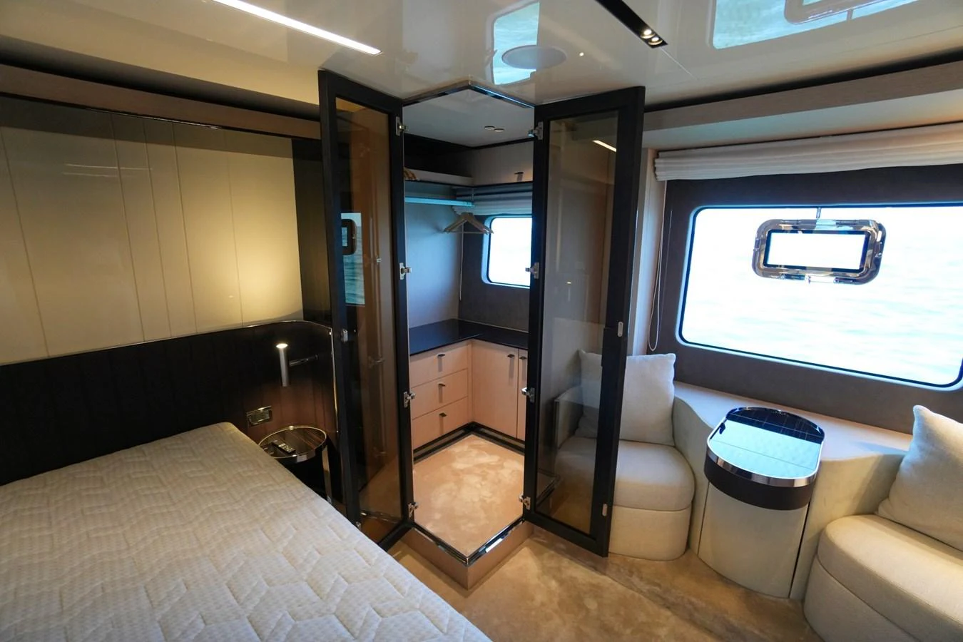 The stateroom features a luxurious bed, ample storage, and large windows for natural light. aboard AMY Yacht for Sale