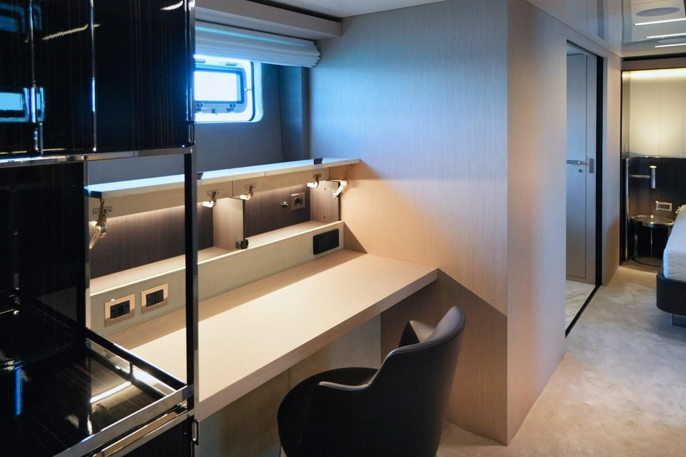 A modern stateroom featuring a sleek desk area with ample lighting and a comfortable chair. aboard AMY Yacht for Sale